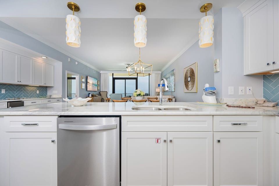 Cook and gather in this elegant kitchen design with a beachfront view and create lasting vacation memories