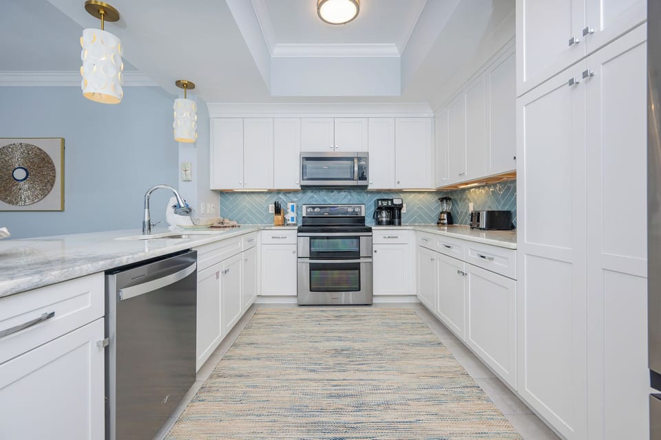 Prepare meals in this stylish kitchen, featuring stainless appliances, ample counter space, and a welcoming vibe