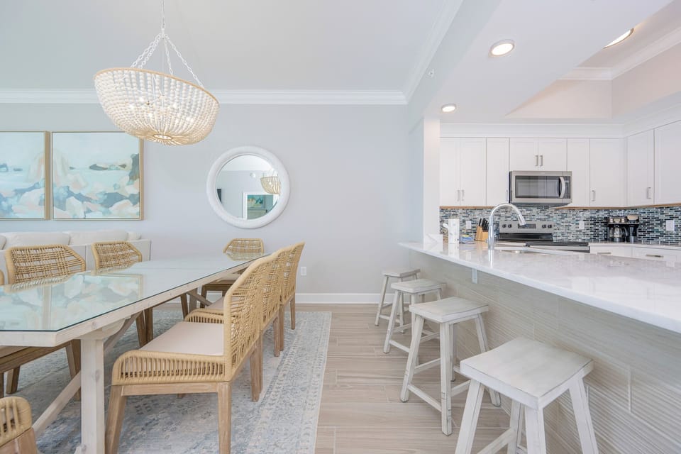 Gather around the dining table or breakfast bar, surrounded by stylish decor and inviting vibe