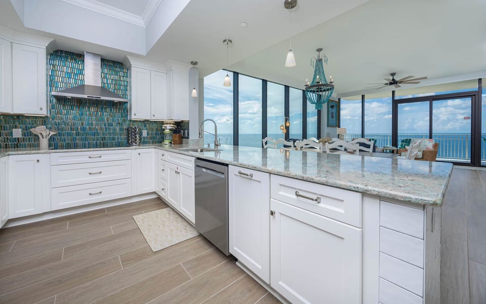 Prepare meals in this kitchen featuring a stunning backsplash, stylish counters, and modern appliances