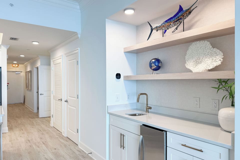 Pour your favorite drink at the wet bar and surround yourself with stylish coastal decor and accents