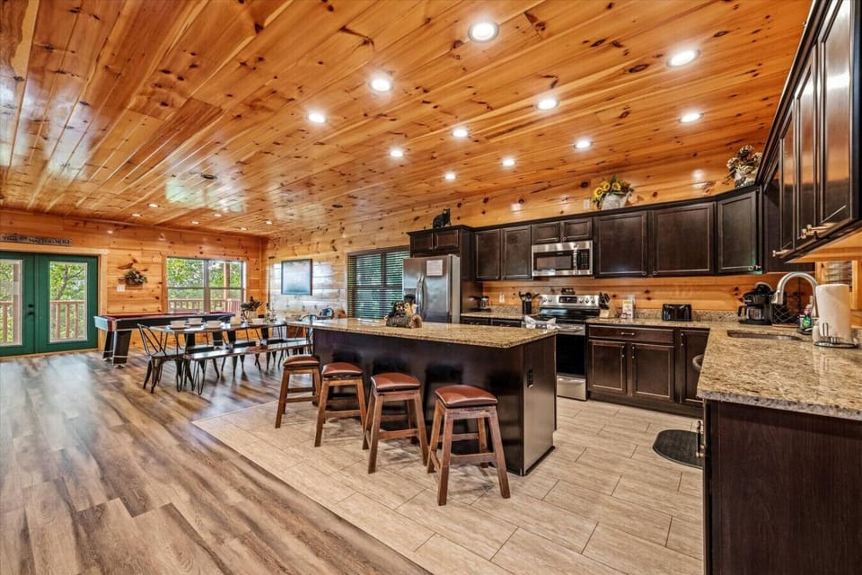 The open layout seamlessly connects the kitchen, dining, and game area—perfect for gathering, grazing, and playing without missing a moment.