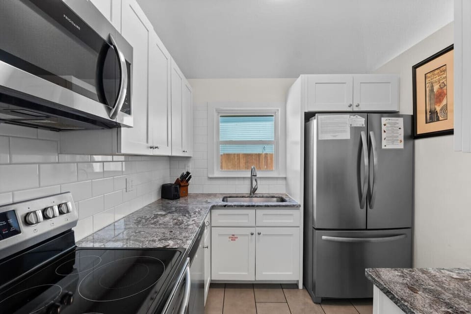 Cook with ease in this bright, fully equipped kitchen featuring stainless steel appliances and everything you need for a home-cooked meal.
