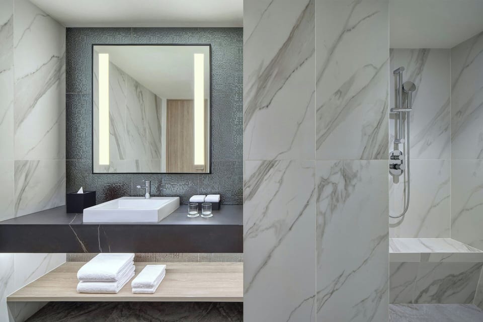 Junior Suite, 1 King Bed (View) | Bathroom | Free toiletries, hair dryer, slippers, towels