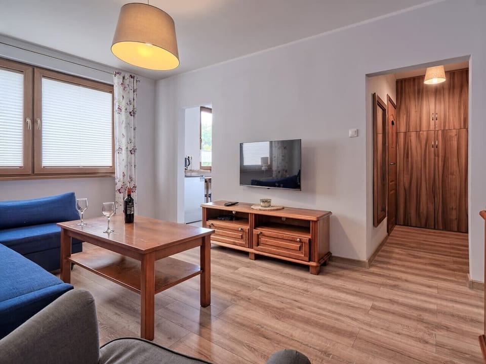 Living Area with Sofa Bed, Dining Table and Smart TV | Book Now with RENTUJEMY.COM