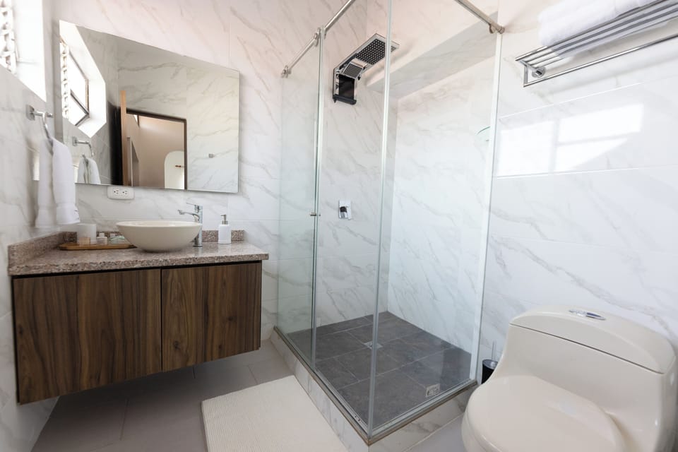 Exclusive Double Room, Courtyard View | Bathroom | Shower, rainfall showerhead, free toiletries, towels