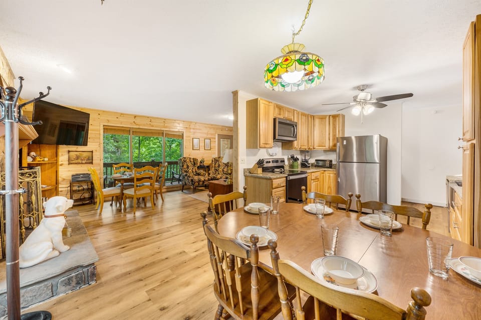 Spacious open-concept living and dining area designed for gathering. Comfortable seating, natural light, and easy flow into the kitchen make this space perfect for meals, movie nights, and relaxing together.