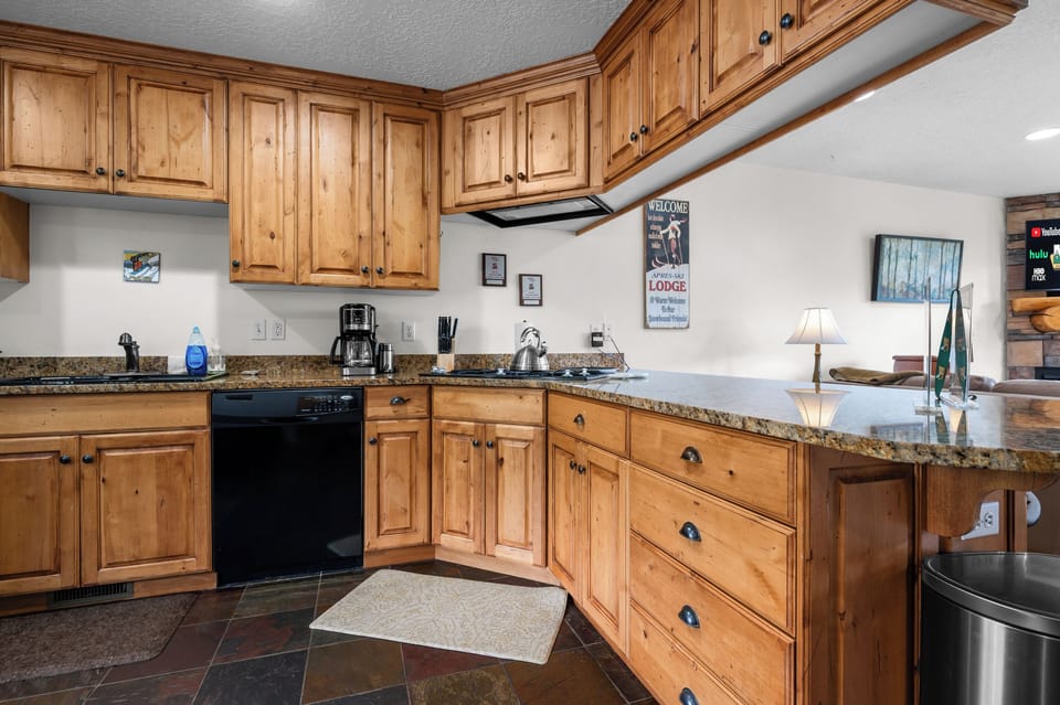 The fully equipped kitchen offers ample counter space, rustic cabinetry, and everything needed for easy meals after a day of adventure.