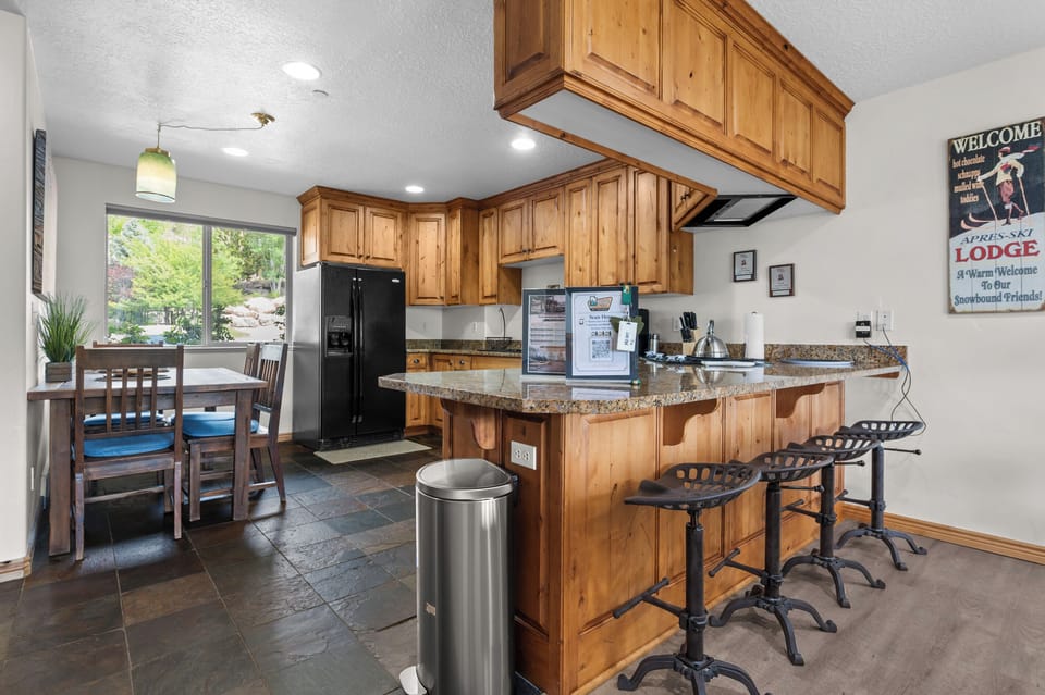 The kitchen bar seats four, perfect for sipping coffee or keeping the cook company.