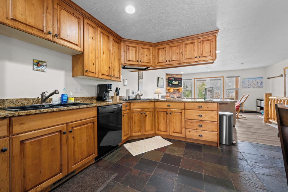 Gather in the spacious kitchen featuring beautiful wood cabinetry, generous prep space, and an open layout perfect for entertaining.