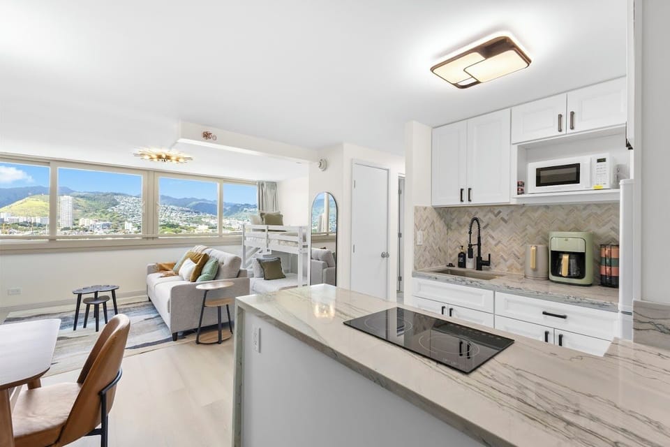 Open-concept living with sweeping mountain and city skyline views
