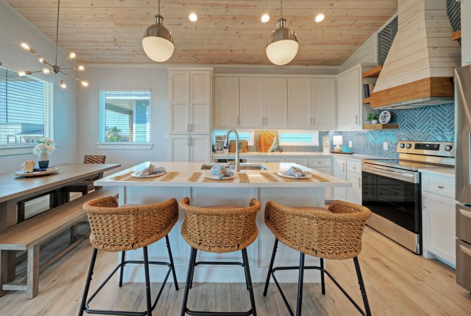 Fully equipped kitchen with barstool seating.