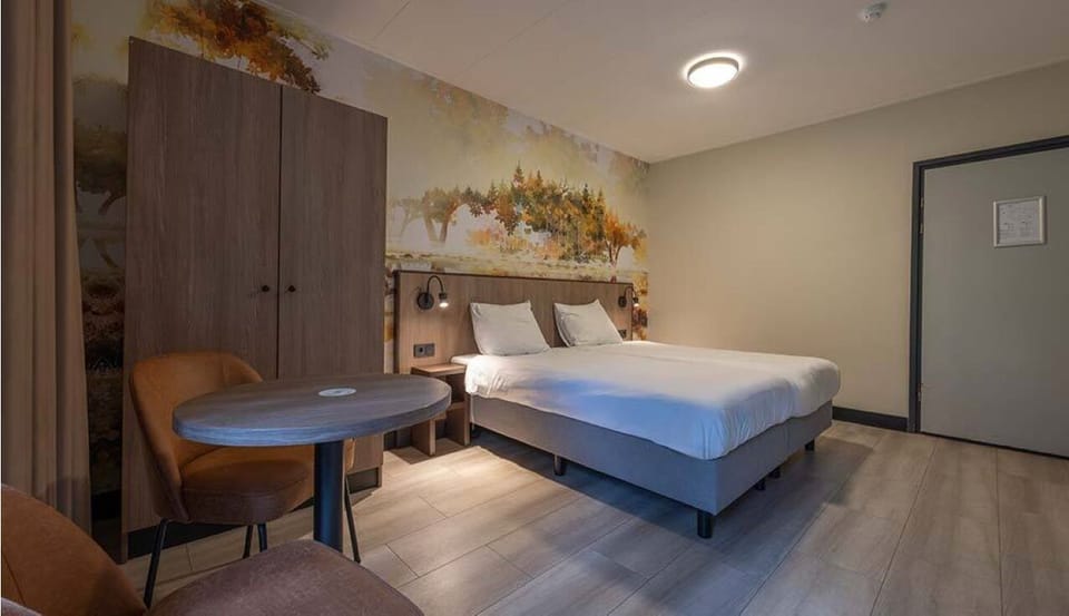 Drift off in a spacious double room with soft, warm lighting.