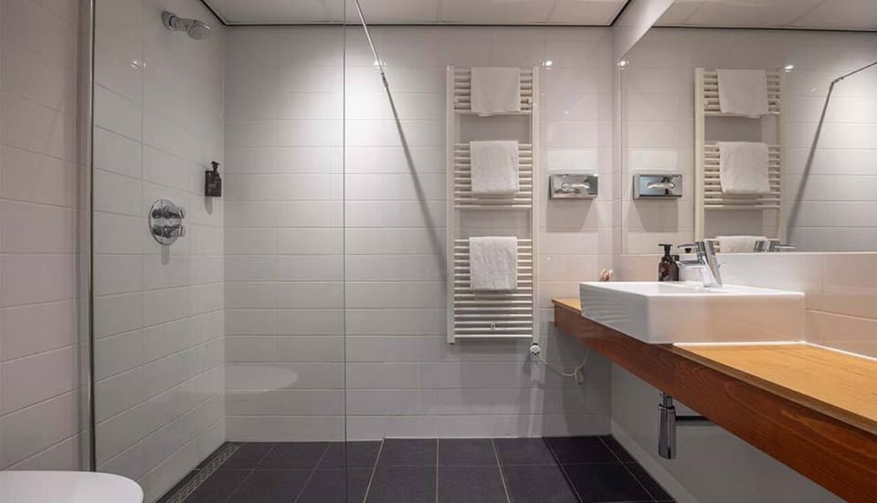 Start your day with a roomy shower and fluffy towels.