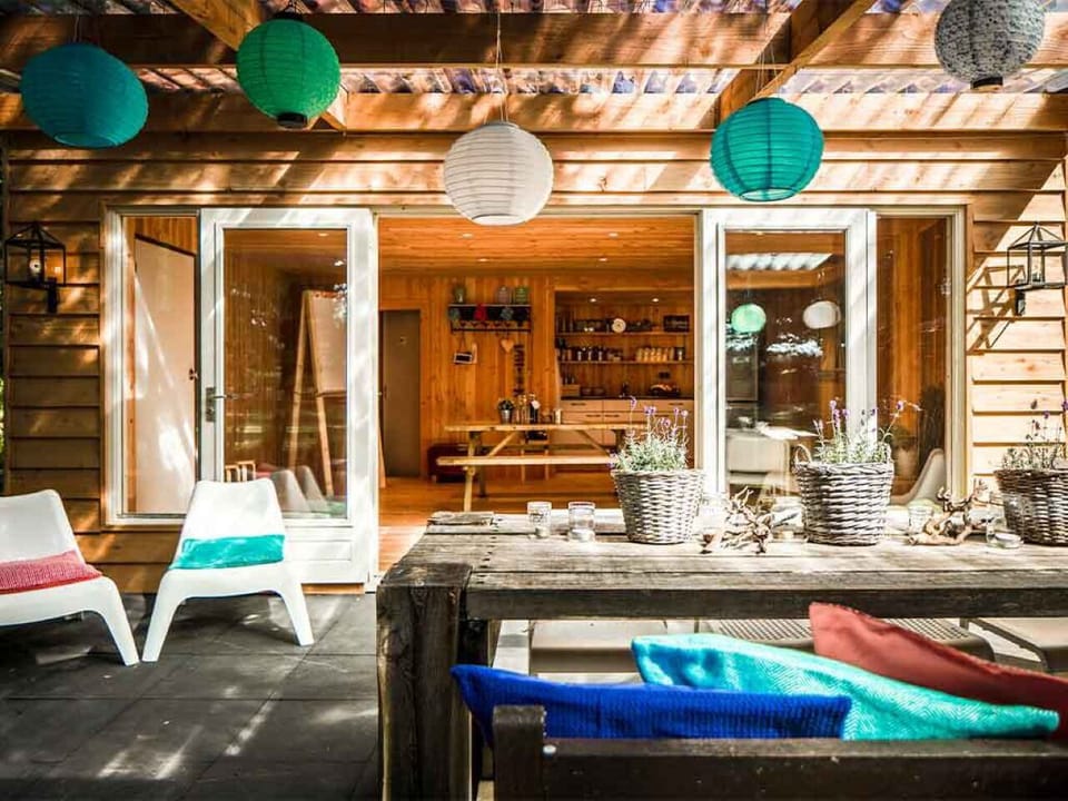 Unwind under lantern glow with drinks on the covered terrace.