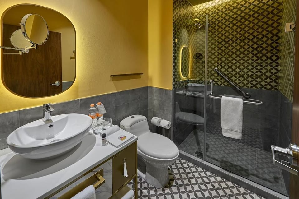 Refresh after adventures in a chic, glass-walled rainfall shower.