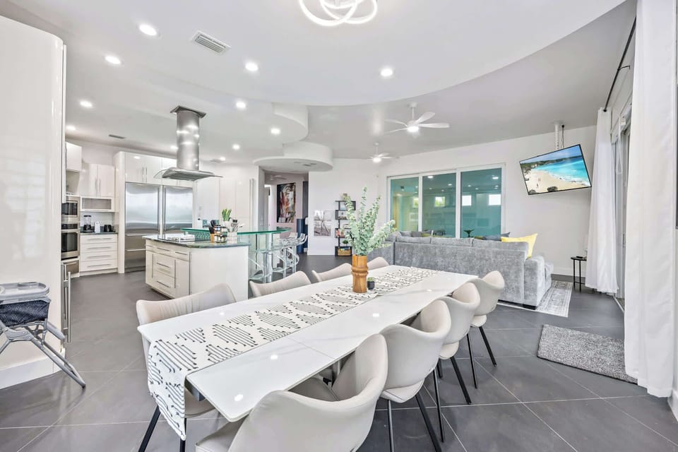 Modern open-concept kitchen and dining area with sleek finishes and ample seating.