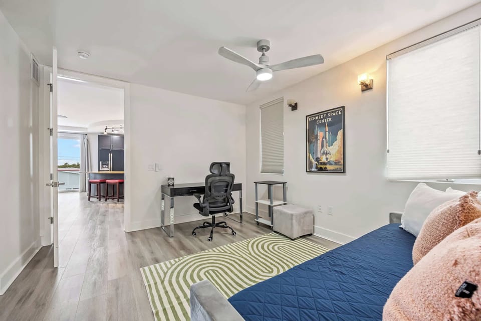 Modern room with a workspace and a view into the kitchen area