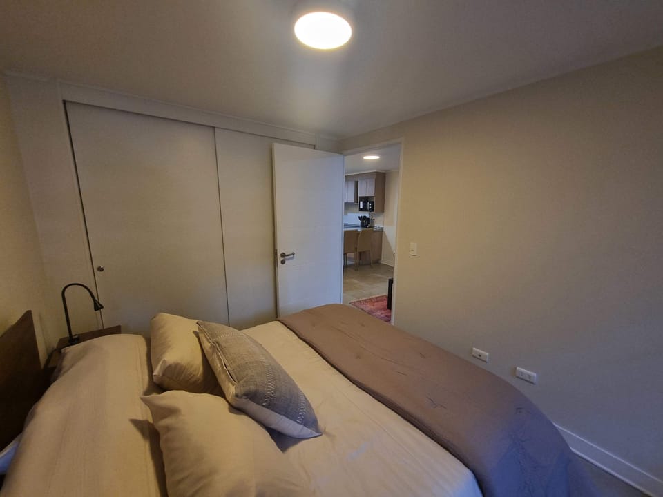 Relax in this cozy bedroom with easy access to the kitchen, perfect for a comfortable stay in the heart of the city.