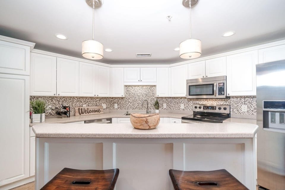 The kitchen has a comfortable breakfast bar with additional seating for entertaining guests and family