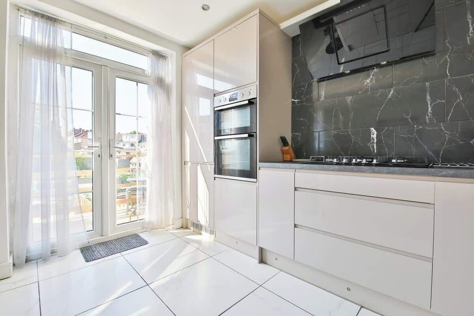 Patio doors lead to a decked area, with steps down to the garden patio and private parking.