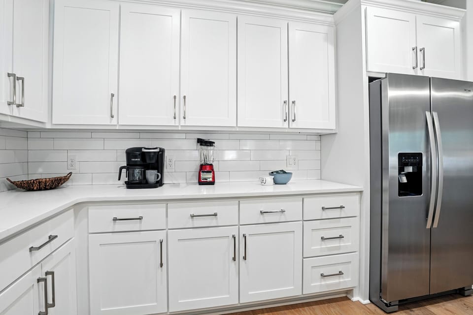 Kitchen Coffee Bar and Full-Size Fridge - Coffee setup, refrigerator space, microwave, and storage keep daily basics close at hand.