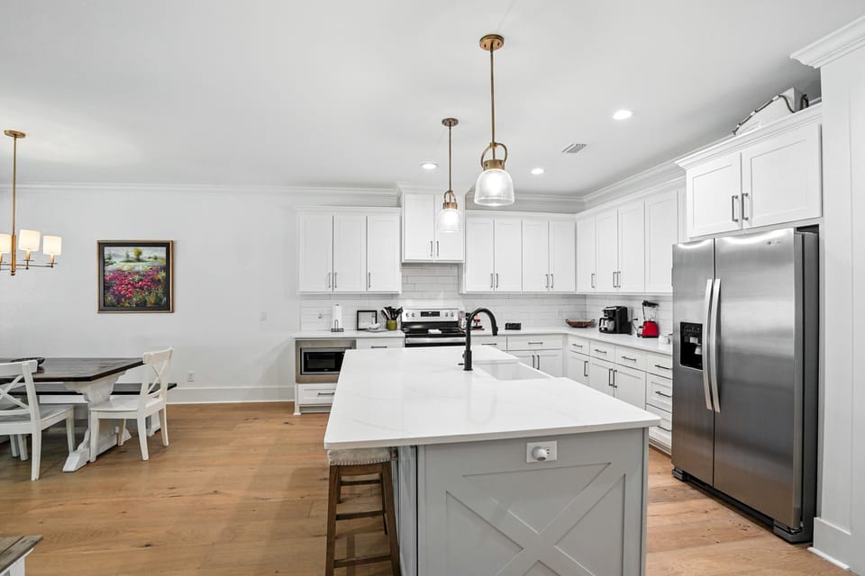 Full Kitchen with Bar Seating - Pendant lighting, island seating, and stainless appliances support everyday cooking.