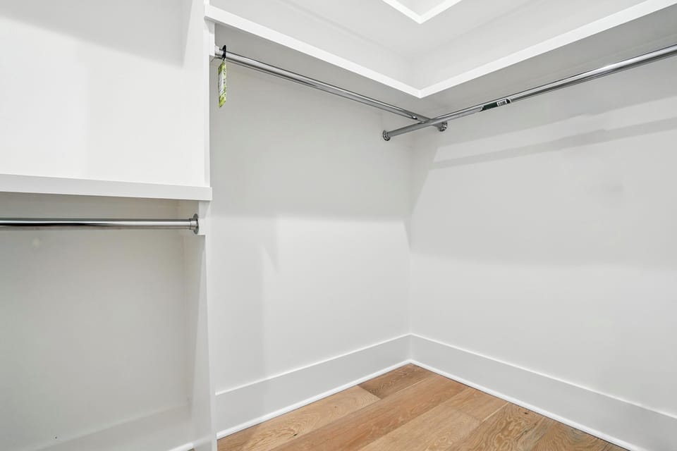 Primary Suite Walk-In Closet - Built-in shelves and hanging space give guests room to unpack during longer stays.