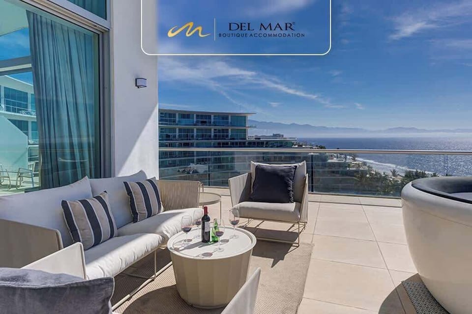 Balcony seating w/ cushioned chairs overlooking the coastline