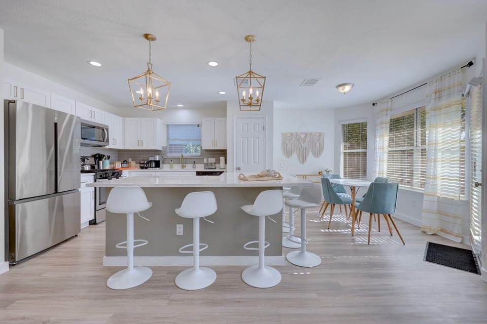 Bright, cheerful, and made for connection—grab a stool, prep a snack, or chat over coffee while sunlight streams through the breakfast nook. The perfect space to start or end your day.