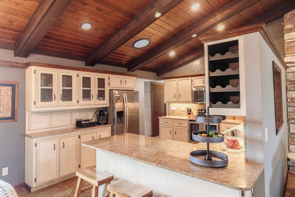 Fully stocked kitchen featuring stainless steel appliances and an eat-in counter with stools, perfect for cooking, casual meals, or morning coffee. Designed for convenience and gathering, this space makes it easy to enjoy meals at home.