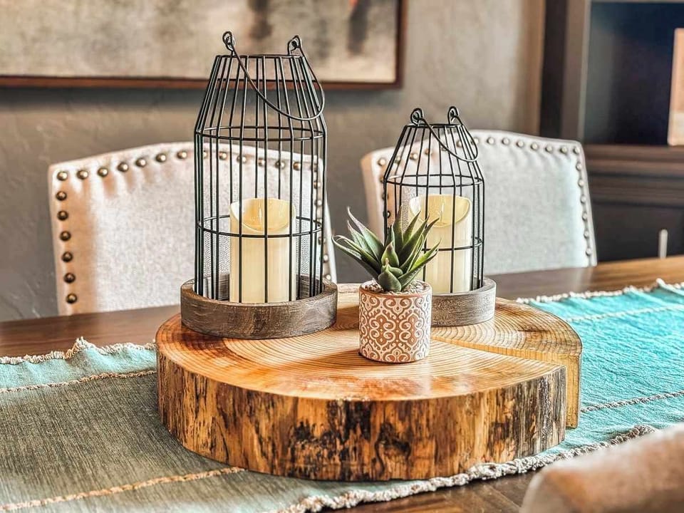 A charming close-up of the kitchen table decor, featuring a stunning wood slab centerpiece crafted from a 50-year-old pine tree, adding rustic warmth and natural beauty to the open-concept space.