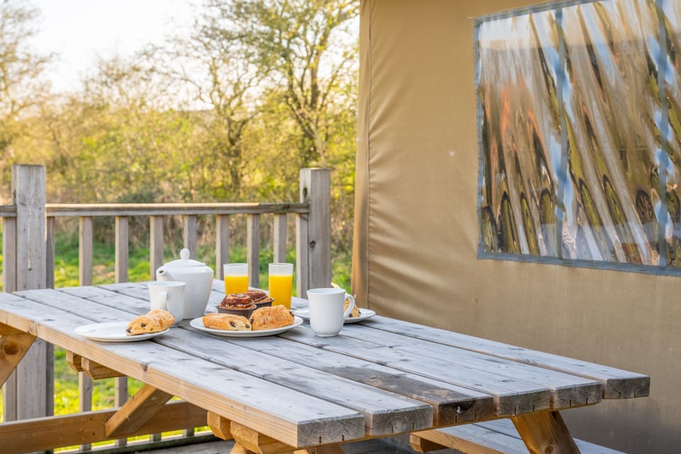 Each tent includes a picnic table on the decking