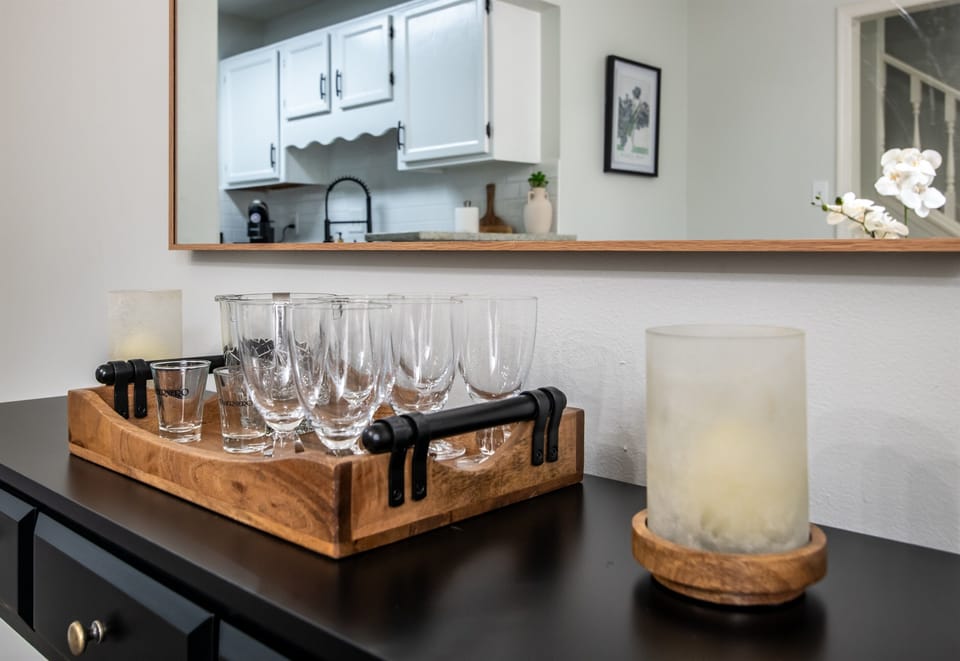 Elegant bar setup with wine glasses and candles, adding a touch of sophistication to the kitchen area.