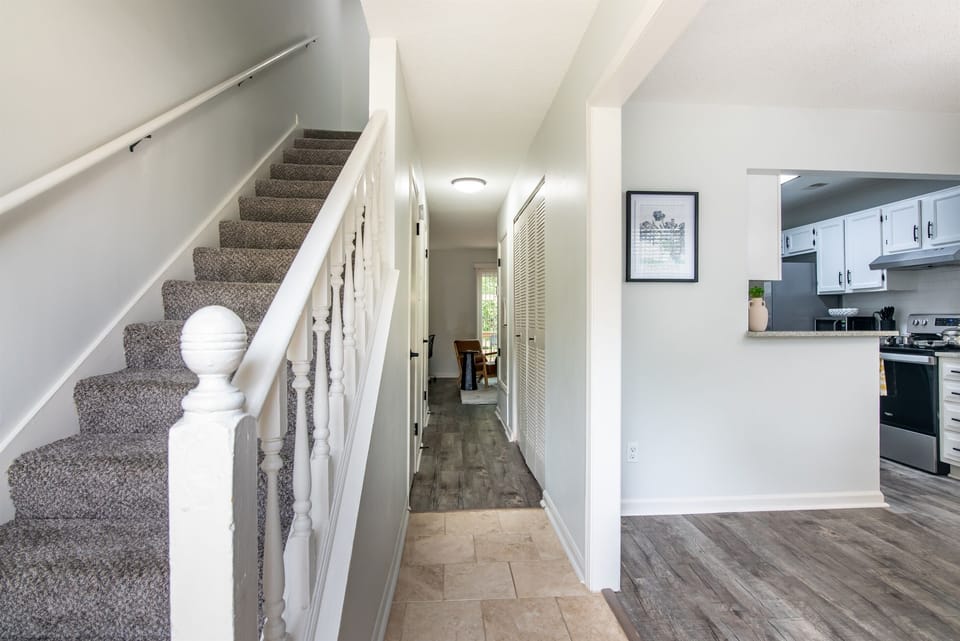 Clean and welcoming stairway view with neutral tones and modern railing, adding character and depth to the home's interior.