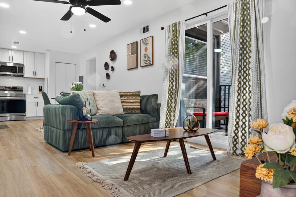 Living Room | With a plush emerald sofa, sleek Smart TV, warm wood accents, and 
