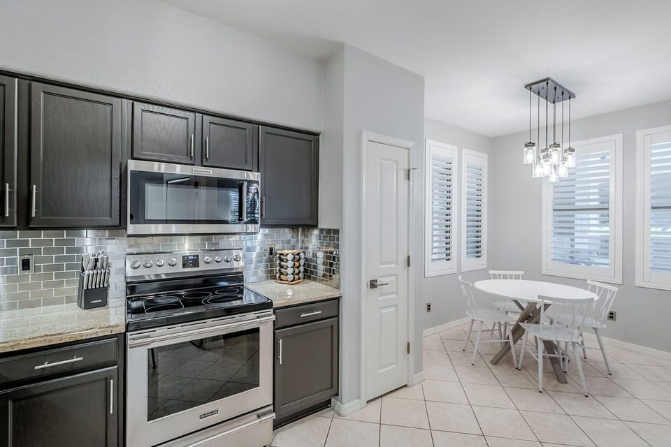 Stylish well stocked kitchen with a dining area adorned with sleek finishes.
