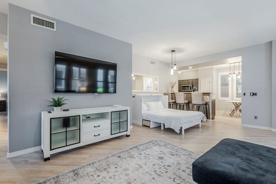 Bright and airy living space with a TV and dining area.