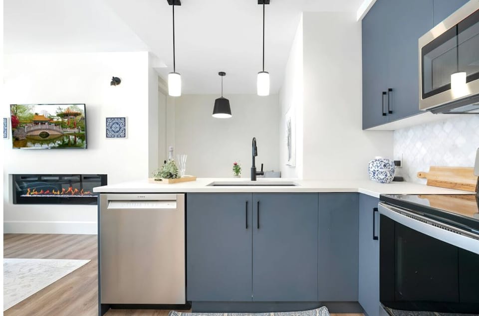 Kitchen overlooks eating bar with 3 stools