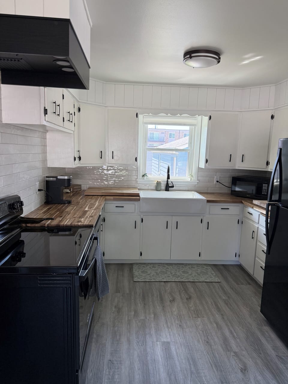 New appliances in a bright and clean kitchen with butcher block countertops