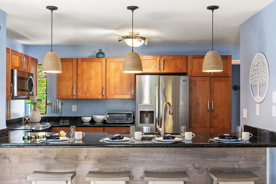 Bright kitchen with pendant lighting and sleek wooden cabinetry.