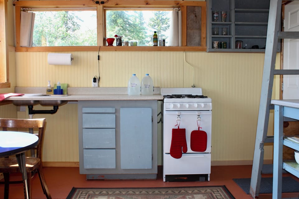 Kitchen with water jugs and range.