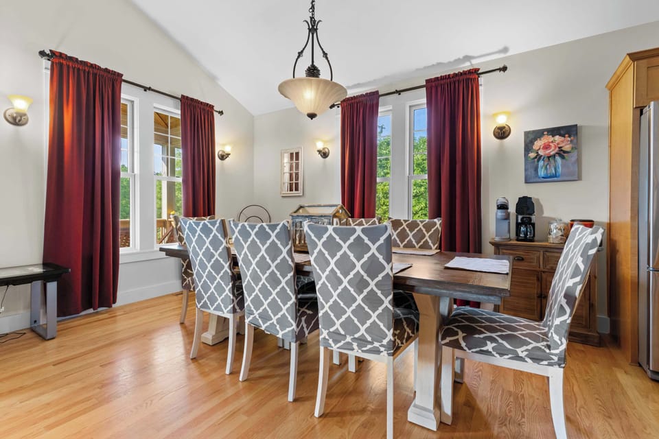 Dining room table seats 8 for an intimate dinner or a game night. Dining area overlooks open living room for extra seating to watch the game.