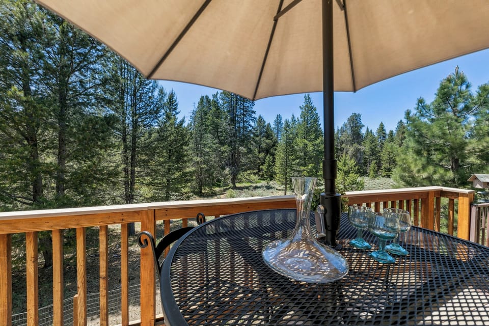 Sip wine at your private deck table while soaking in stunning forest views through towering pines.