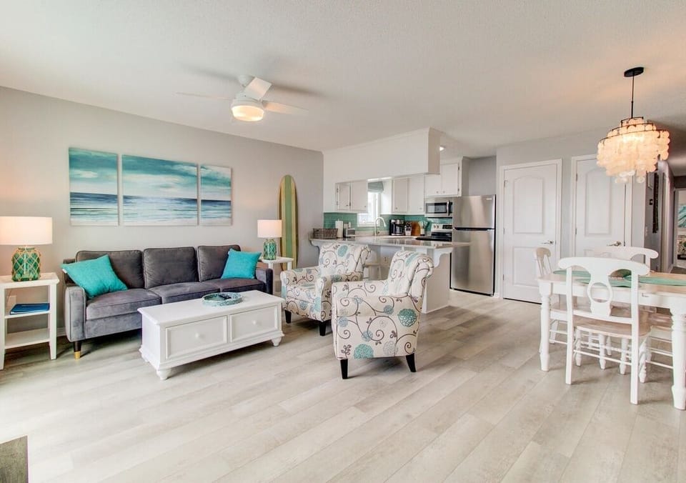 Open concept: living + dining with ocean view