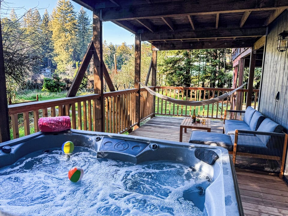 Relax on the spacious deck—hammock, hot tub - & inviting outdoor furniture