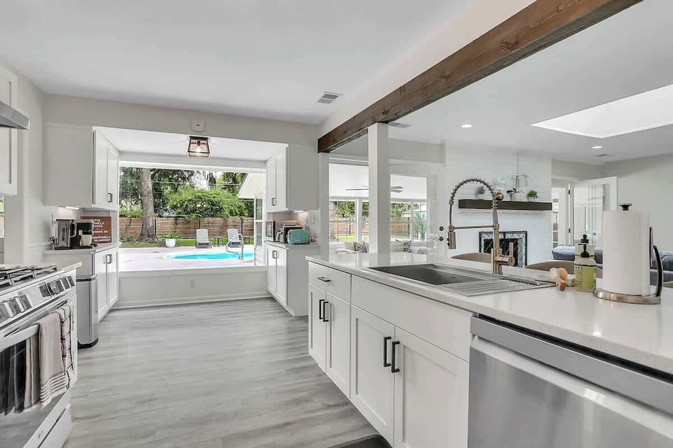 Bright, open, and flooded with natural light. The open concept kitchen overlooks the backyard. 