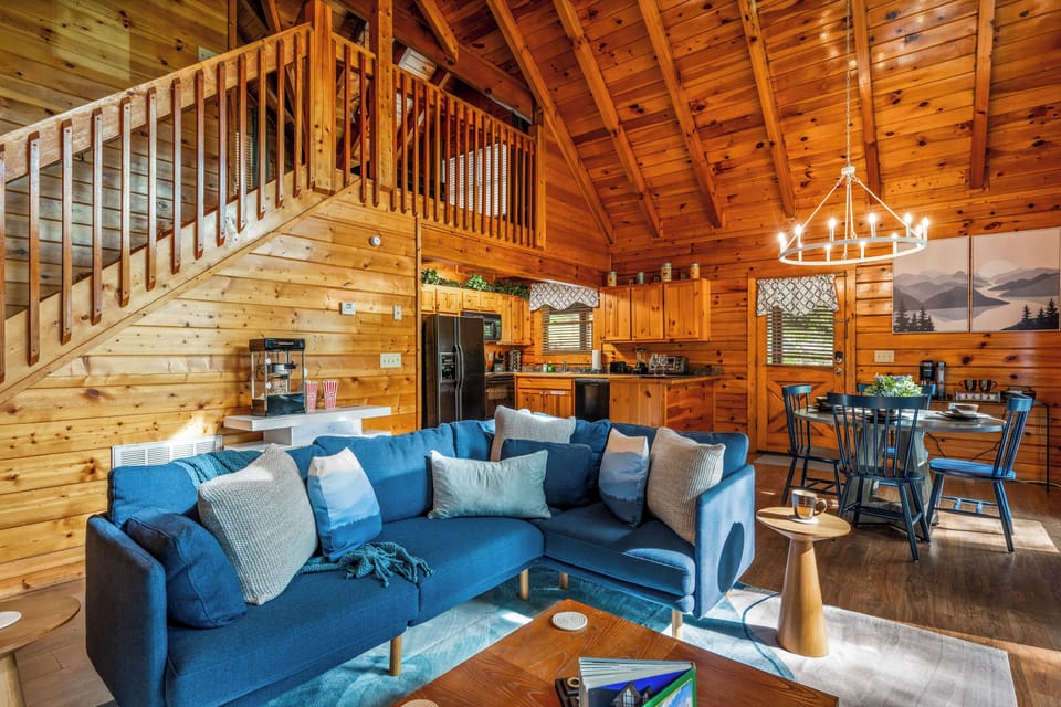 Find your bliss on this charming covered deck, where a bubbling hot tub and a delightful hanging chair await your relaxation. This serene outdoor retreat provides the perfect spot to unwind and enjoy your private cabin experience.