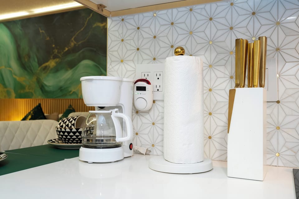 Full kitchen with refrigerator, stove, microwave, coffee maker, toaster