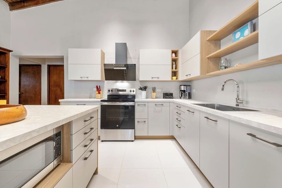 Try local recipes in this fully equipped kitchen, complete with an electric range and oven, microwave, refrigerator, freezer, dishwasher, coffee maker, toaster, breakfast bar, all the cookware and utensils you need, plus island seating for 3